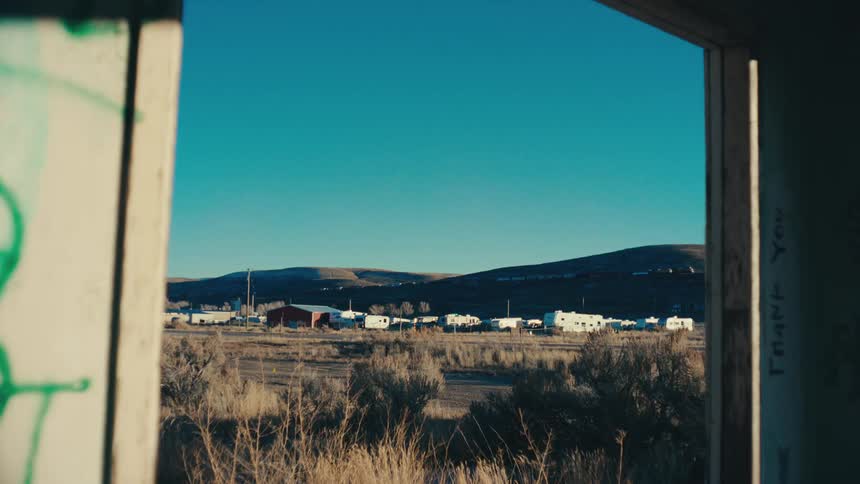 A truck drives past an old town