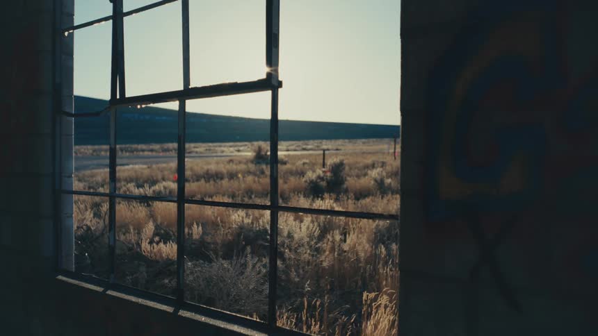 Traffic drives past an old window