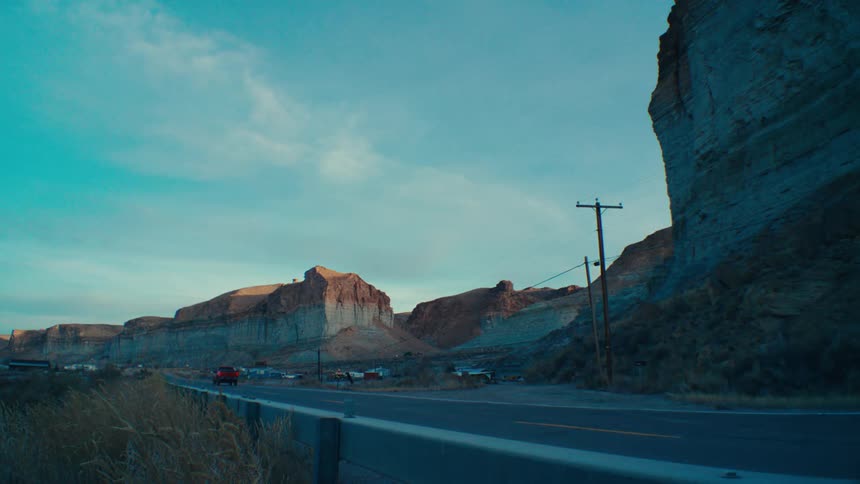 A car drives down the valley road