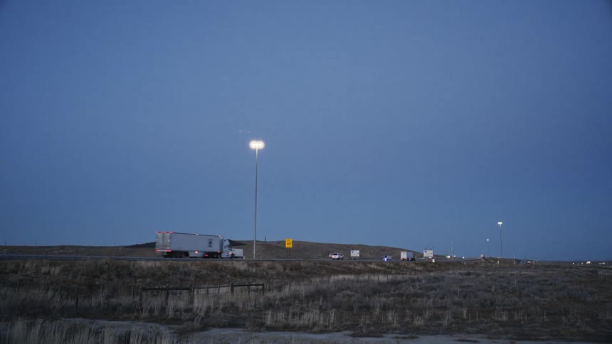 Landscape of a highway with vehicle traffic and mountains around