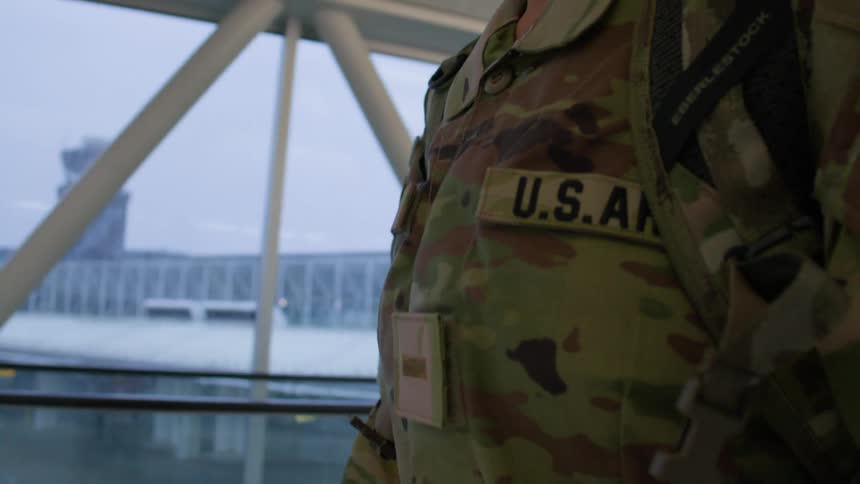 Closeup of a persons military uniform walking in an indoor space