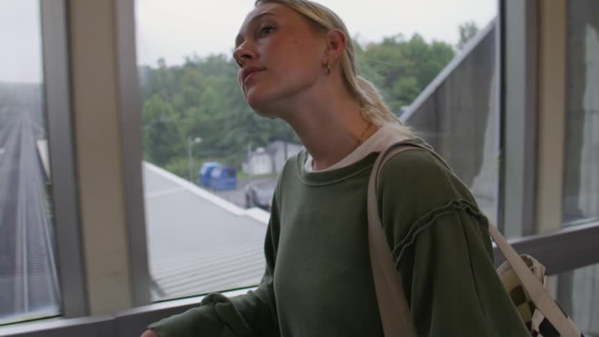 Woman walking down a subway corridor