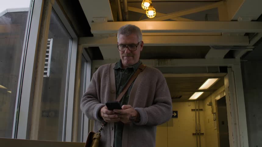 Man walking using his cell phone