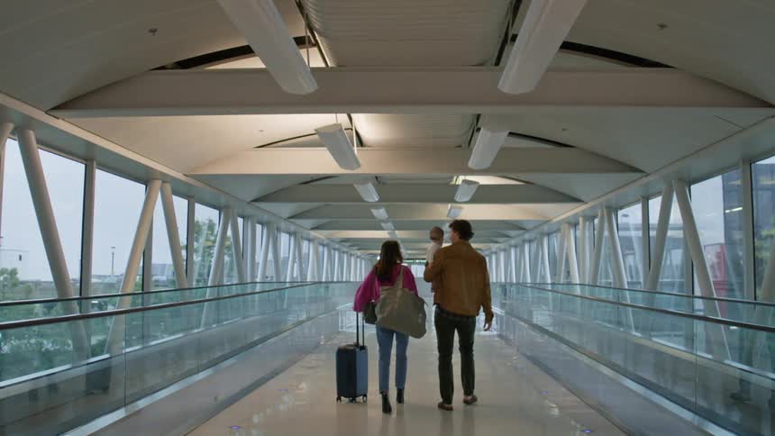 Family walking down a station hallway