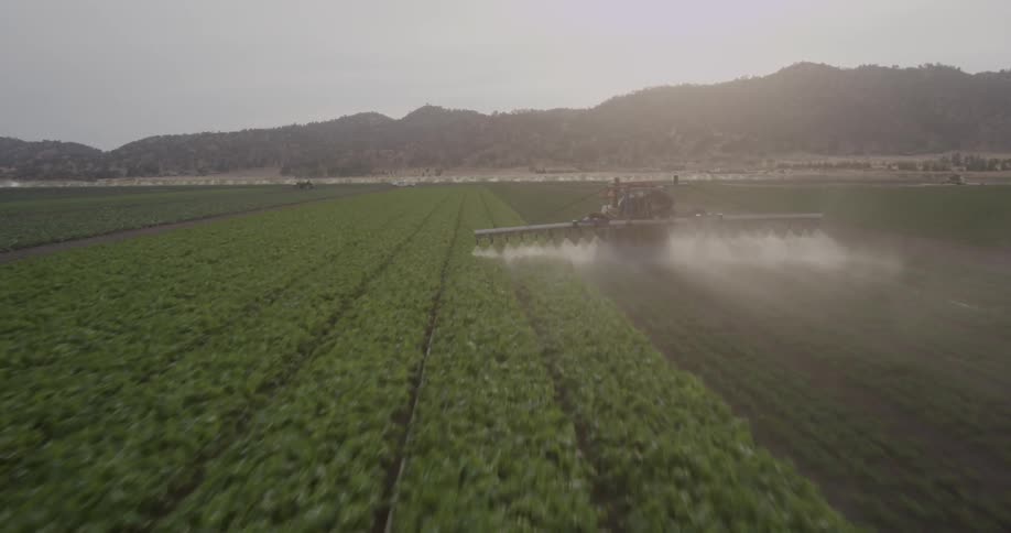 A fast view of a field of crops and a combine