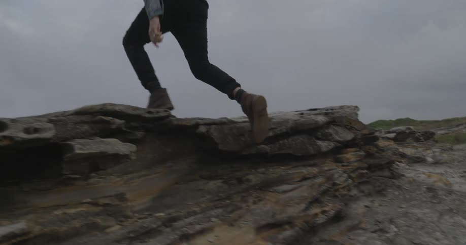 A man sprints up a rocky area