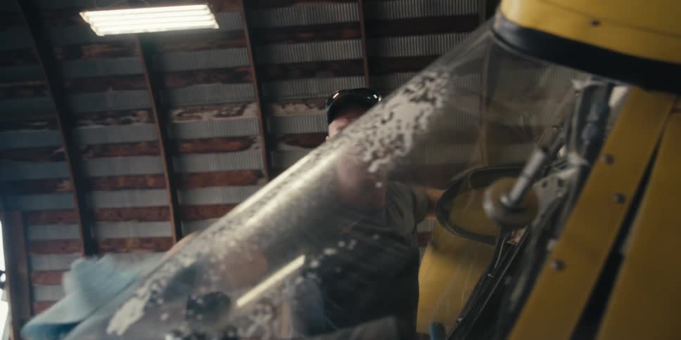 A man cleaning the windshield of the plane