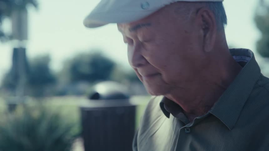 A man looks around on a sunny day