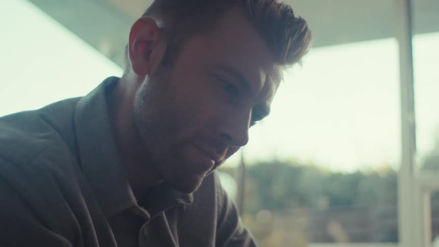 Man looking at a tablet thoughtfully
