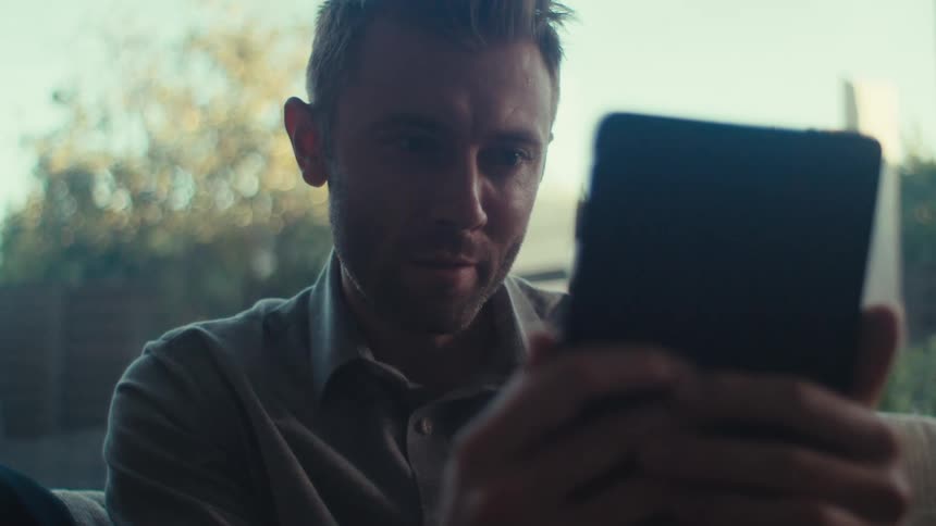 A clip of a person reading from a tablet