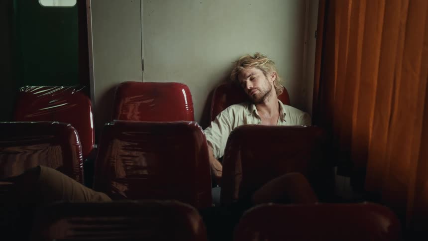 A sleeping man slowly wakes up