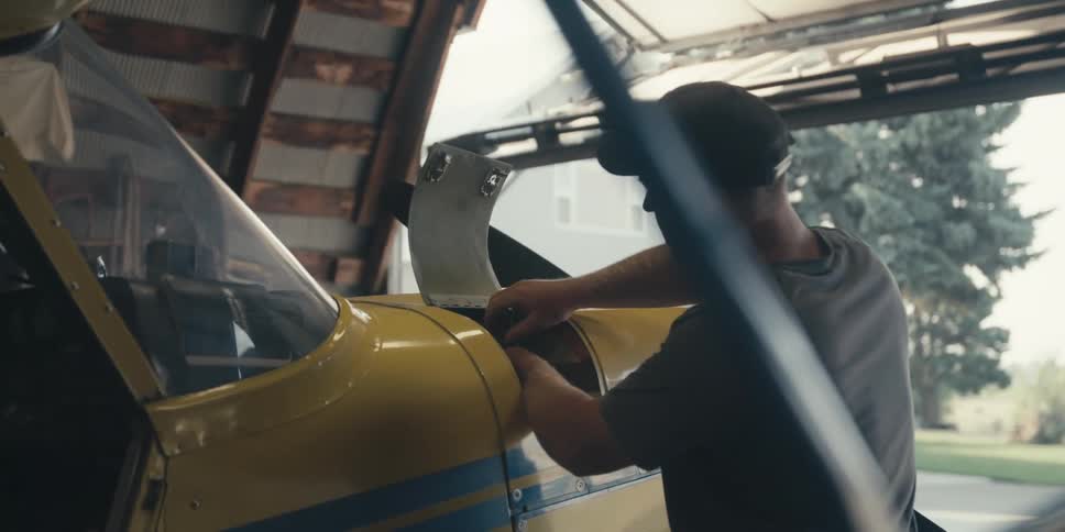 Mechanic checking oil in an airplane engine