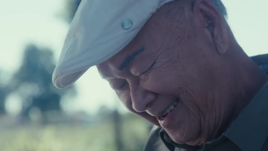 Portrait of a happy senior man sitting outdoors