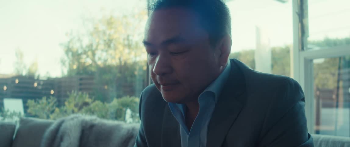 A man touches his chin while thinking about something