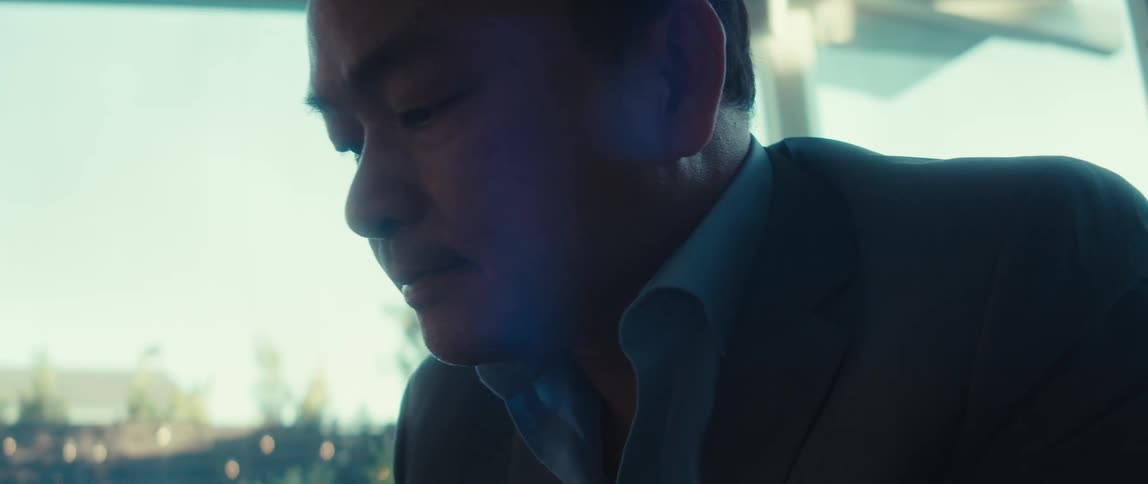Man wearing a suit is sitting in a building by himself