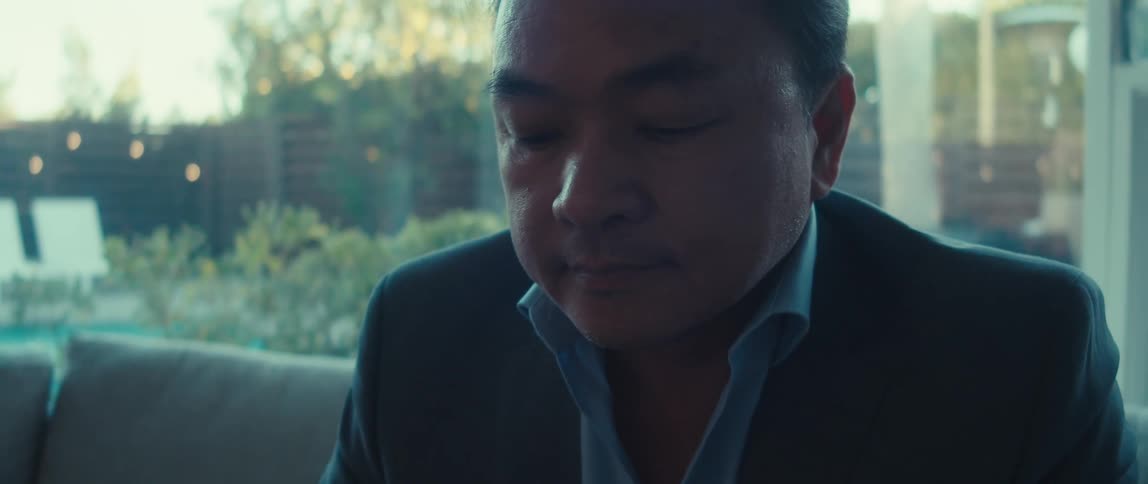 A man looks down at his laptop and types