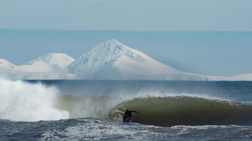 A ma i surfing on a large wave
