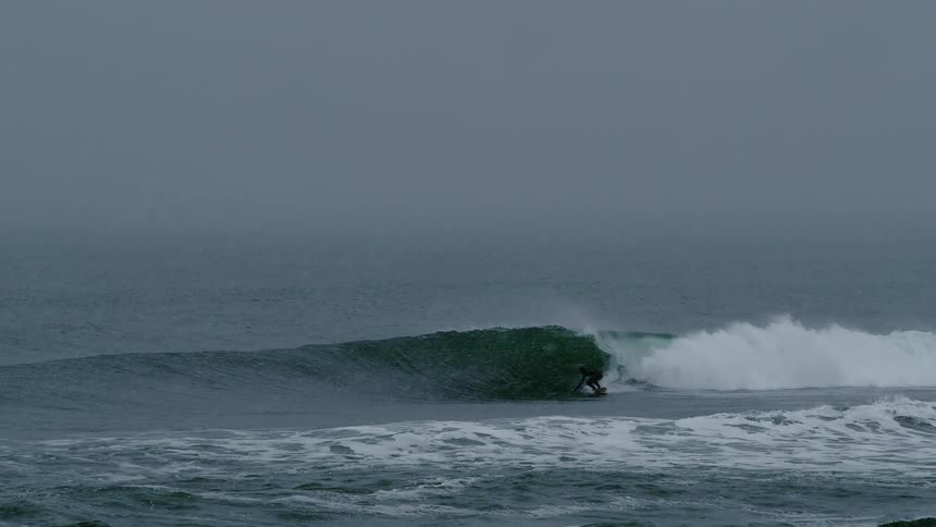 People are surfing as it snows