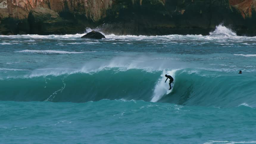 Surfer riding a wave in the ocean