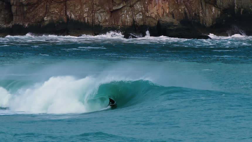 Surfer riding a wave in the ocean