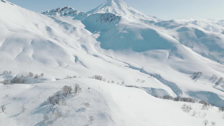 The landscape and mountain are covered with snow