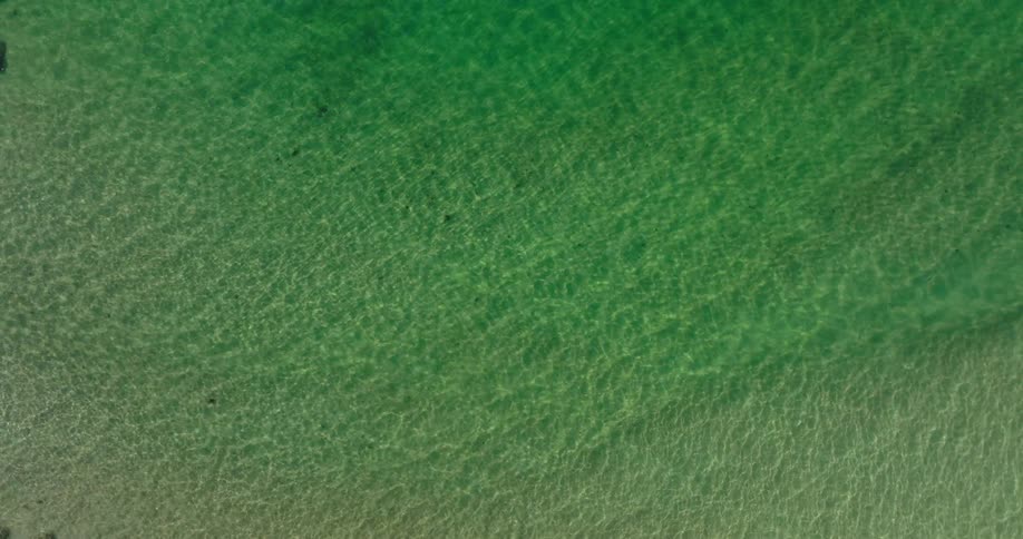 Aerial view of a shallow translucent green body of water