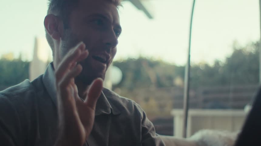 A man talking on a video call at home using a tablet