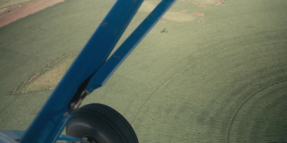 View from a plane of the grain fields and plane shadow below