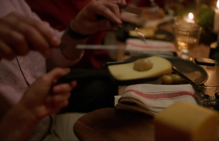 Two people are gathered around a table enjoying a fondue dinner
