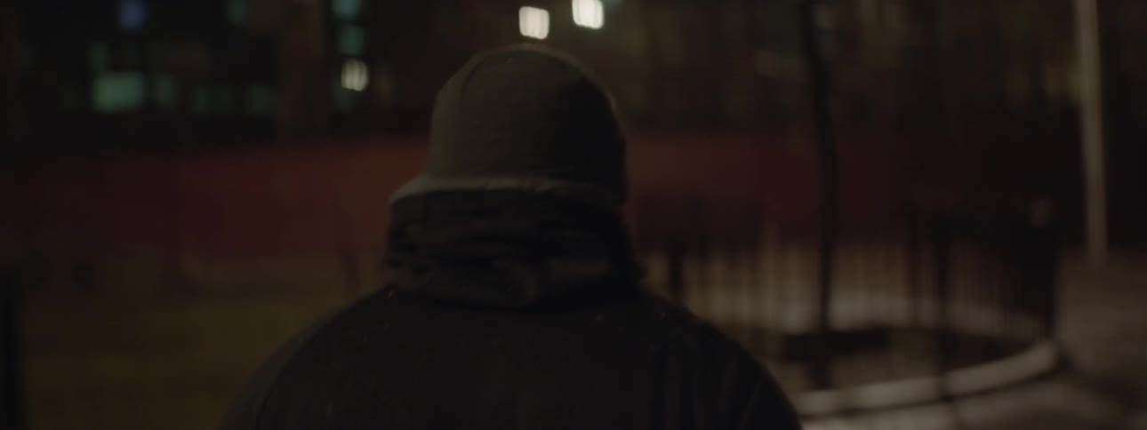 Person walks down a city street at night