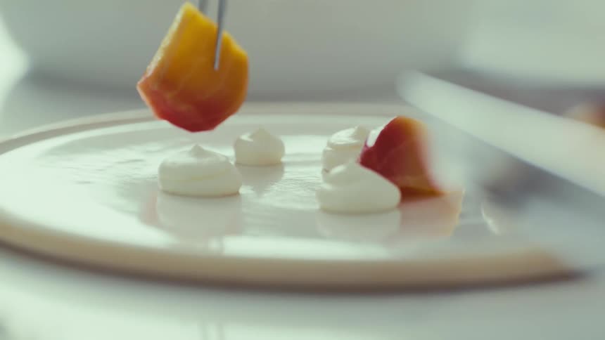 Food is carefully plated with teezers