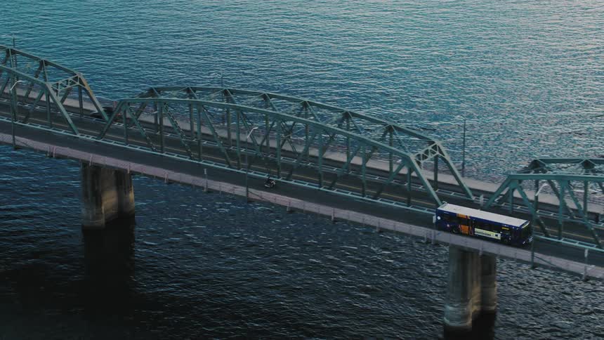A bus cross the very long bridge