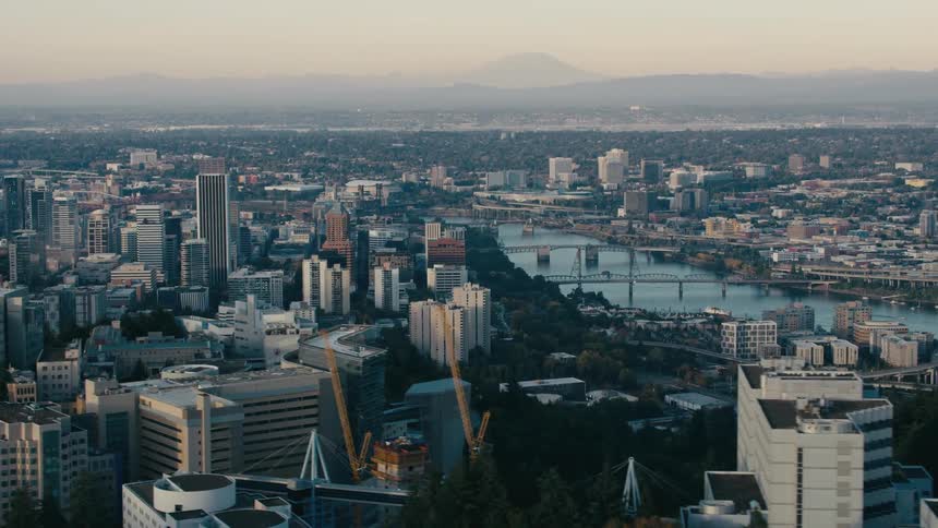 The city skyline stretches out before you a dense network of buildings and bridges