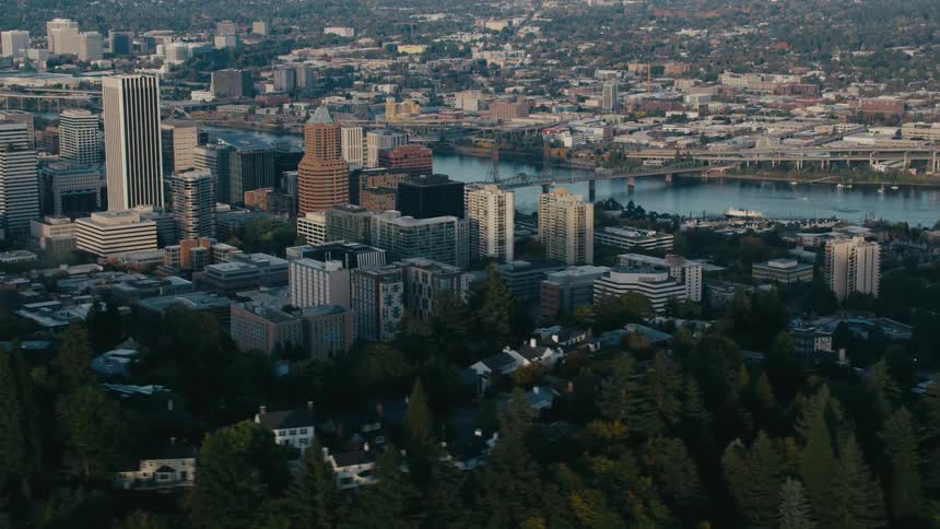 Portlands downtown skyline rises from a mix of urban and forested areas bisected by the willamette river and its bridges