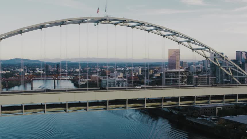 Traffic is flowing over the bridge in the city