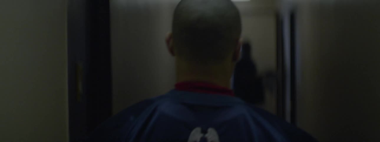 Sports player walking down a hall