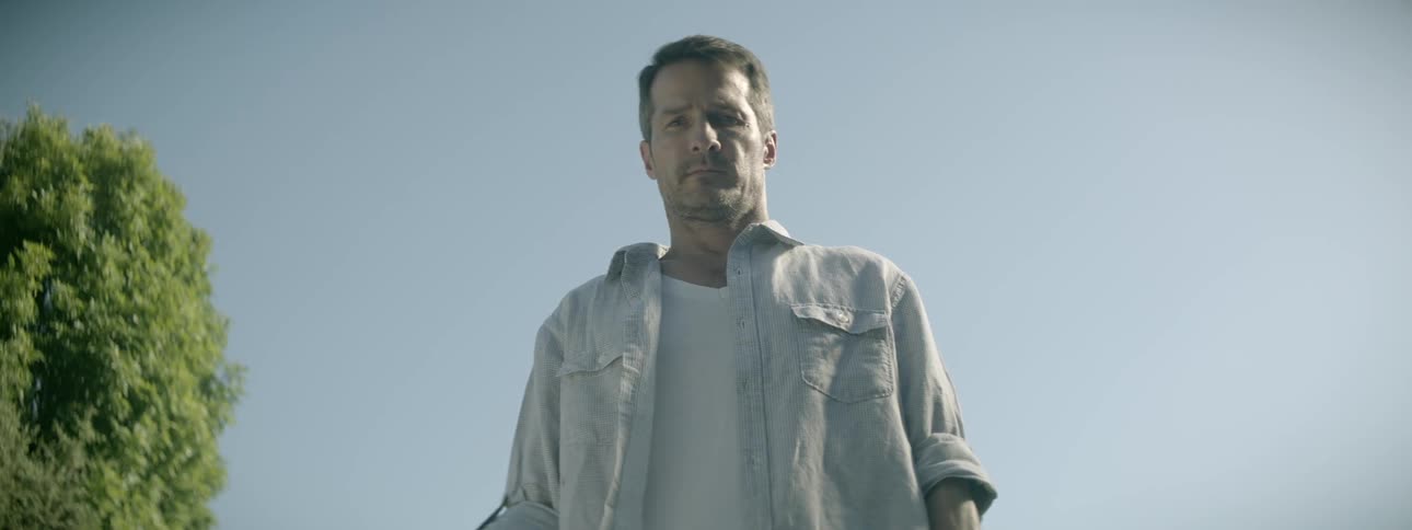 A man looks down blinking slowly