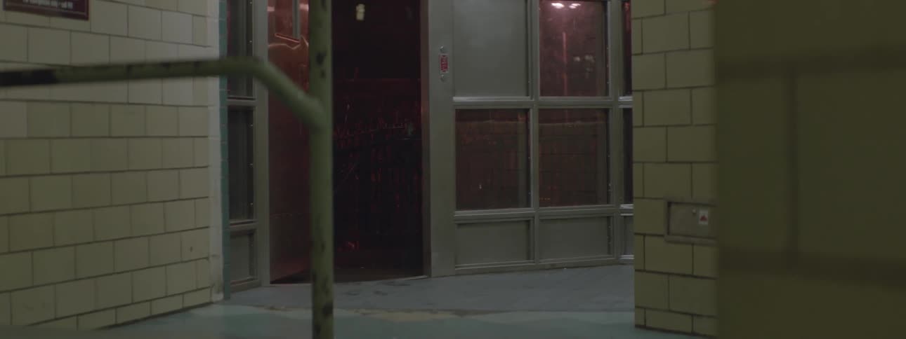 Man walking his small dog on a leash entering a building