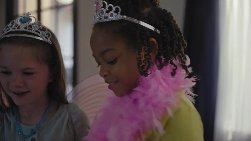 Two children with princess crowns playing together