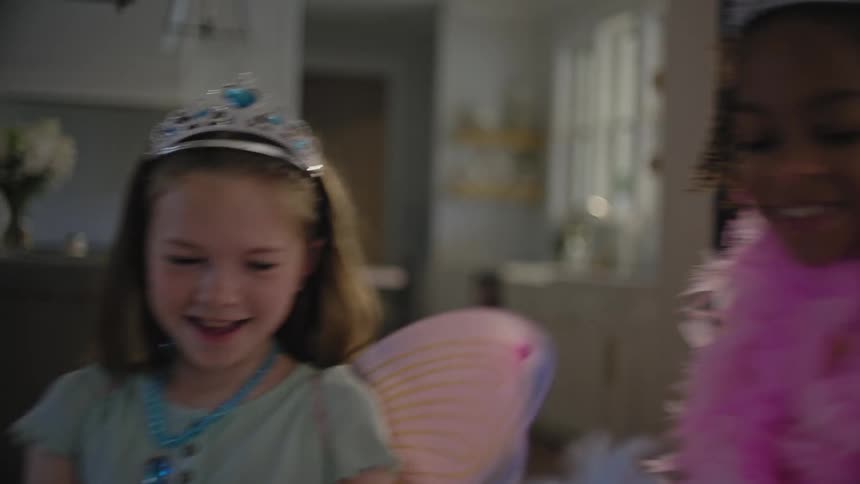 Two young girls play as princesses inside