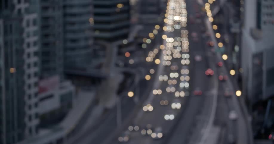 Traffic moving through a large city at dusk