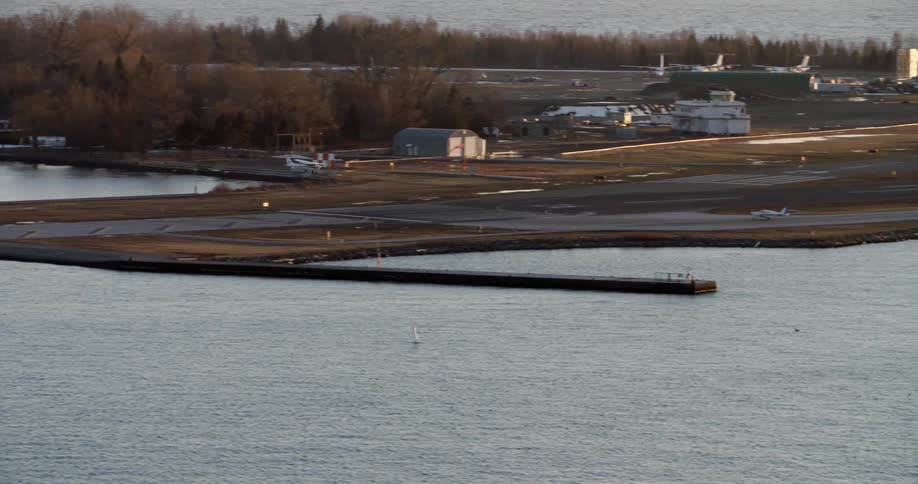 A plane descends to land on a landing strip