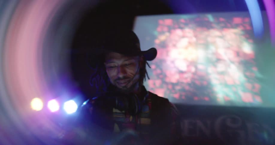Musician dj mixing music in a nightclub at night