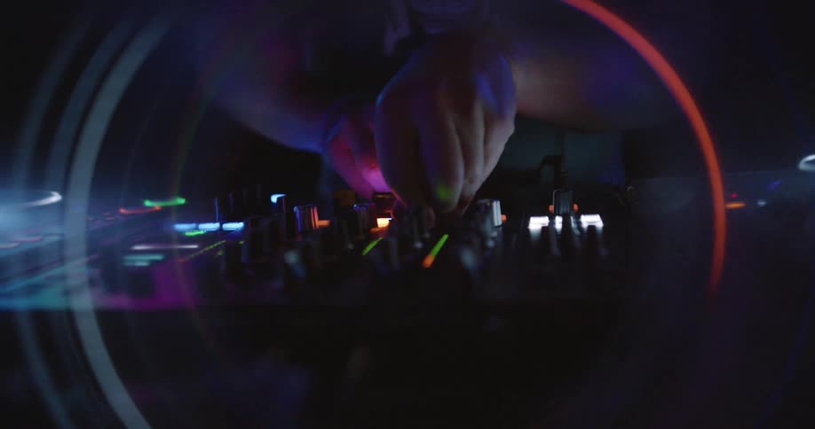 Hands of a dj mixing at a party