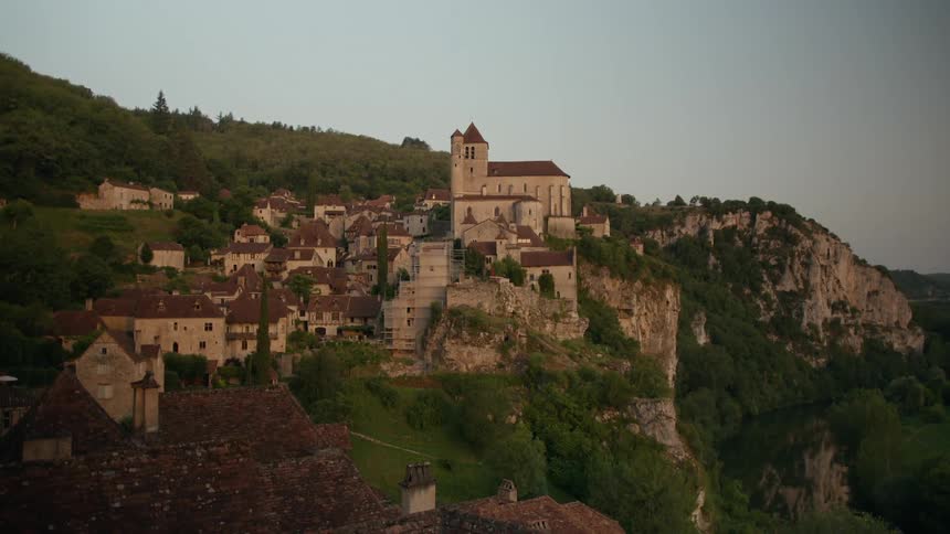 The village clung to the cliffside its stone buildings and a big church blending seamlessly with the rocky landscape