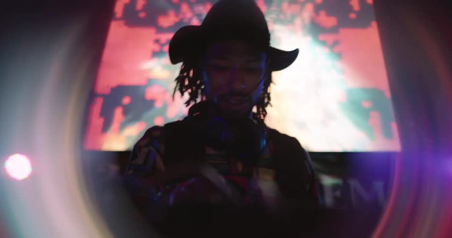 Man in hat mixing at a party