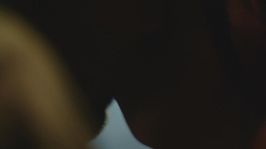 Silhouette of two people kissing