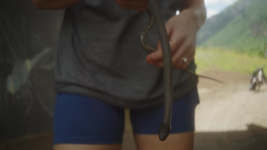 A clip of a person holding a snake