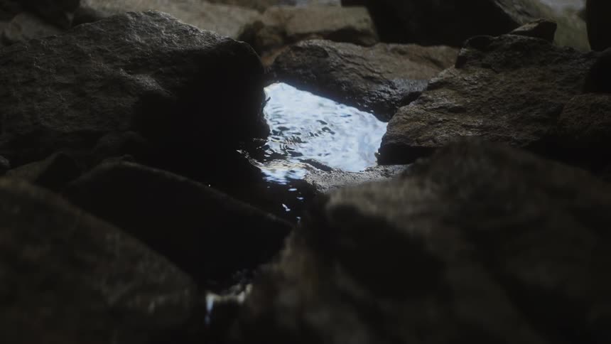 A tiny stream of water passes over the rocks