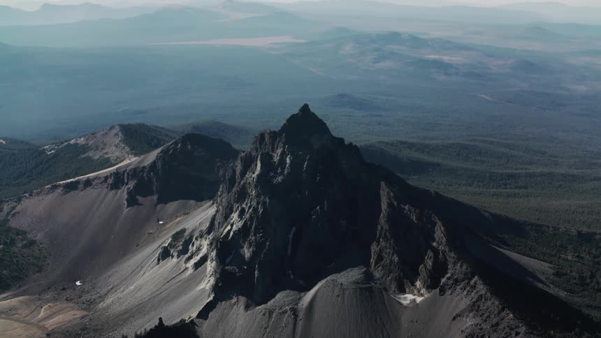 Aerial view of a volcanic mountain formation with steep slopes